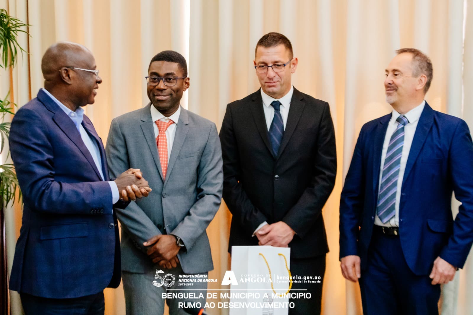 Handshake between Angolan officials and Hungarian delegates at a bilateral meeting