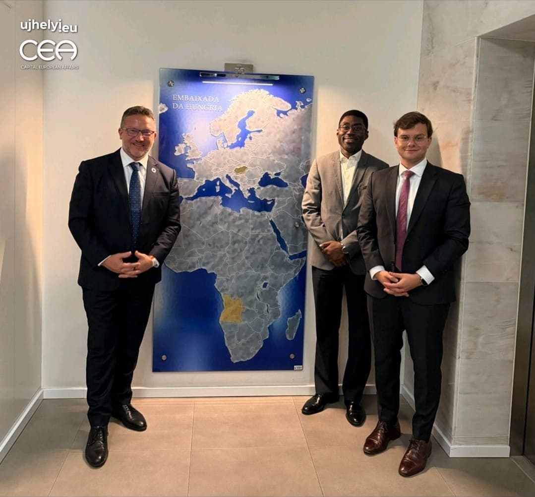 The delegation at the Hungarian Embassy in Luanda, beside a map of Europe and Africa