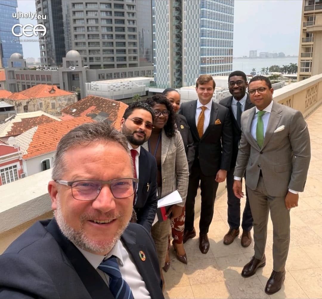 The delegation on a rooftop terrace overlooking central Luanda and the bay
